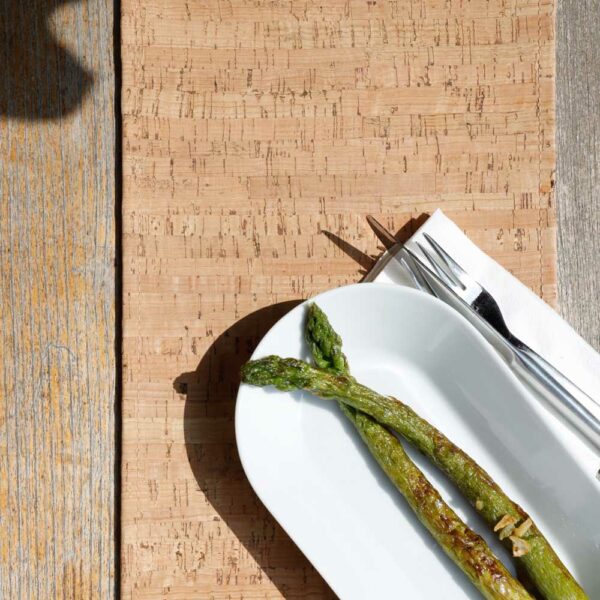 Table runner brown natural color, cork leather product as table decoration for dining room, asparagus on cork